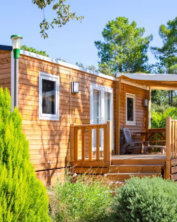 Chalet Premium 2 et sa terrasse, dans le parc arboré de Campo Di Mare